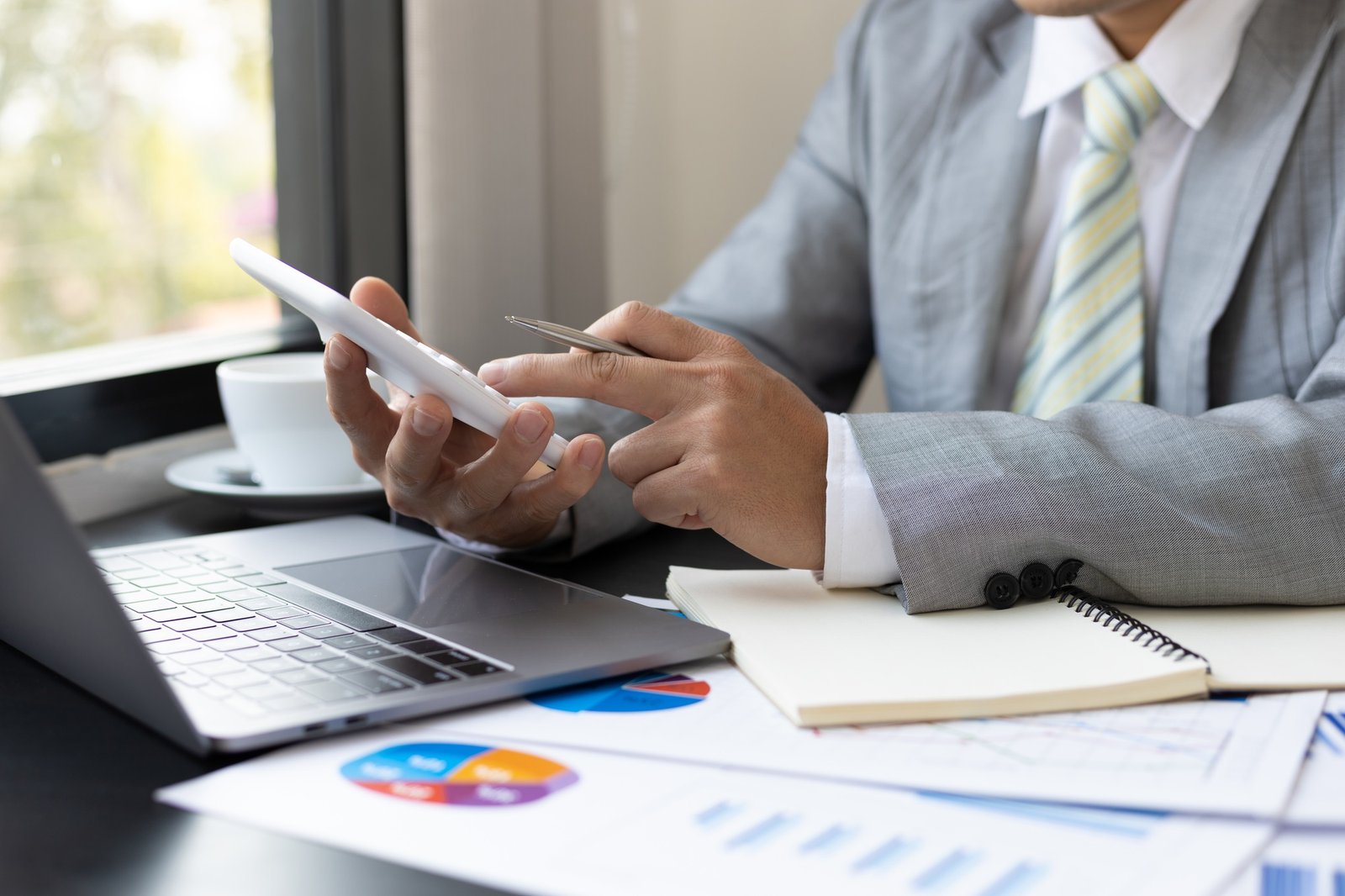 An accountant filing federal and state tax credit paperwork for a client of AP Sun Energy, with documents and a laptop on a desk