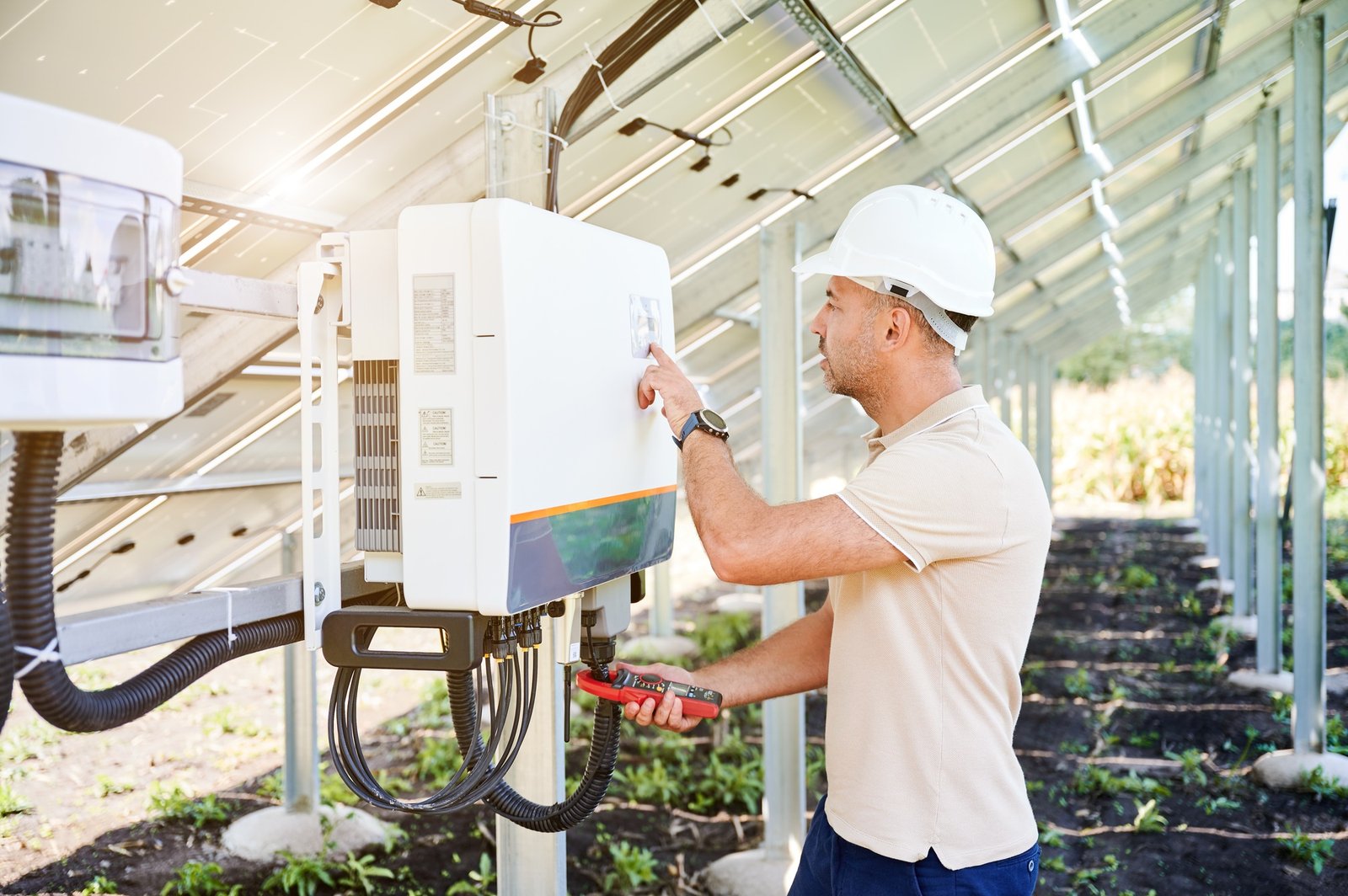 Solar Installer checking voltage on solar inverter.